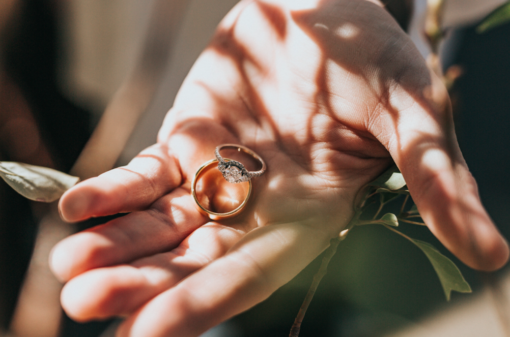 person giving wedding bands