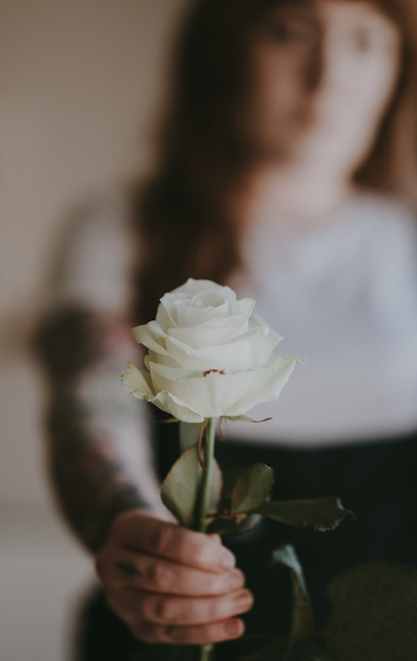 woman giving white rose