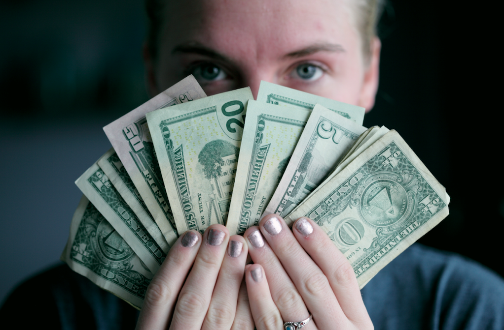 Person with fan of cash