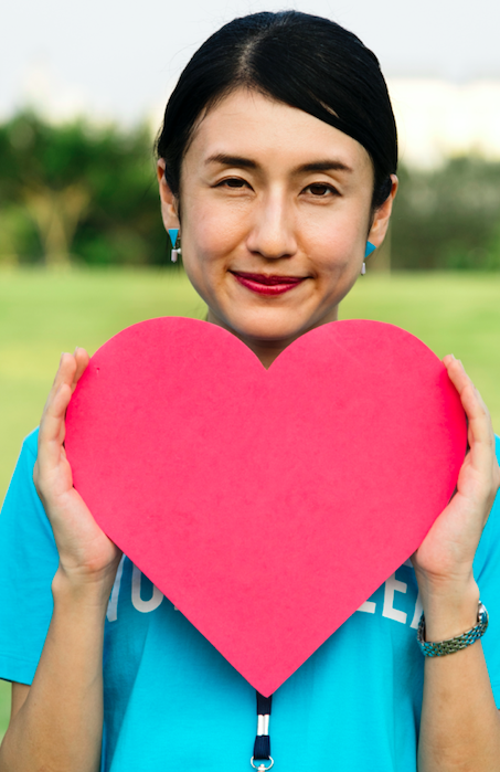 woman holding red heart