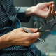 man holding glasses talking about employment policies