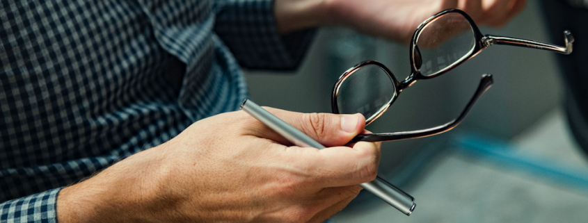 man holding glasses talking about employment policies