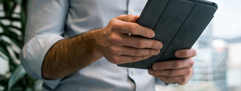 man reading on tablet