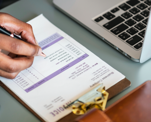 hand filling out tax form