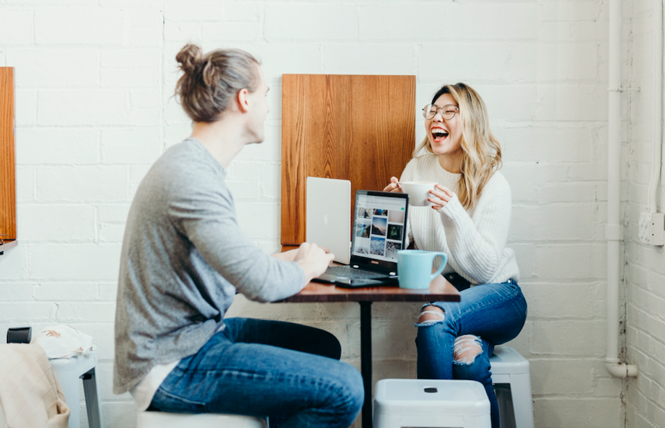 two people talking at table