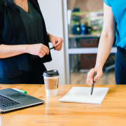 Two woman at board meeting table