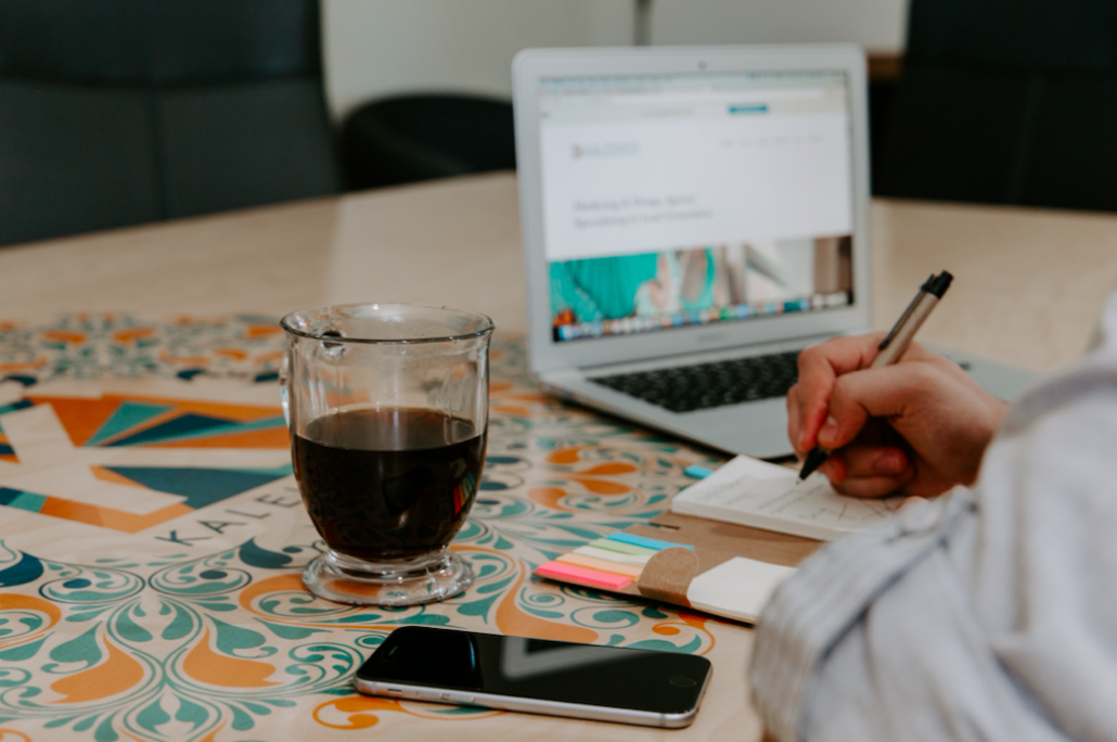 writing on desk with coffee and phone