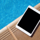 july newsletter tablet by pool
