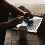 person with laptop at table