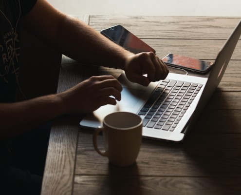 person with laptop at table
