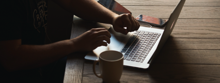 person with laptop at table