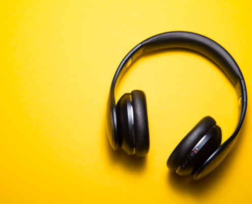 black headphones against yellow background