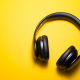 black headphones against yellow background