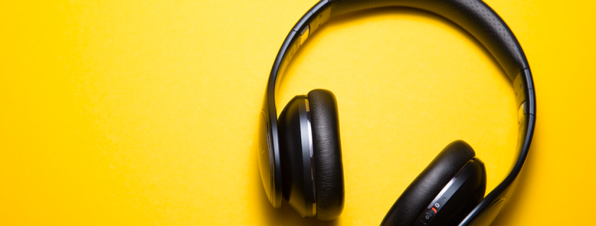 black headphones against yellow background